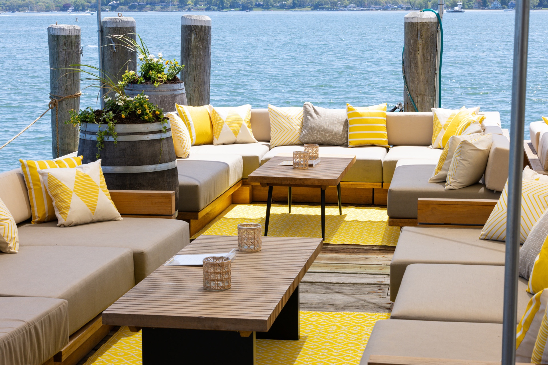 Dockside lounge seating with yellow pillows over the bay