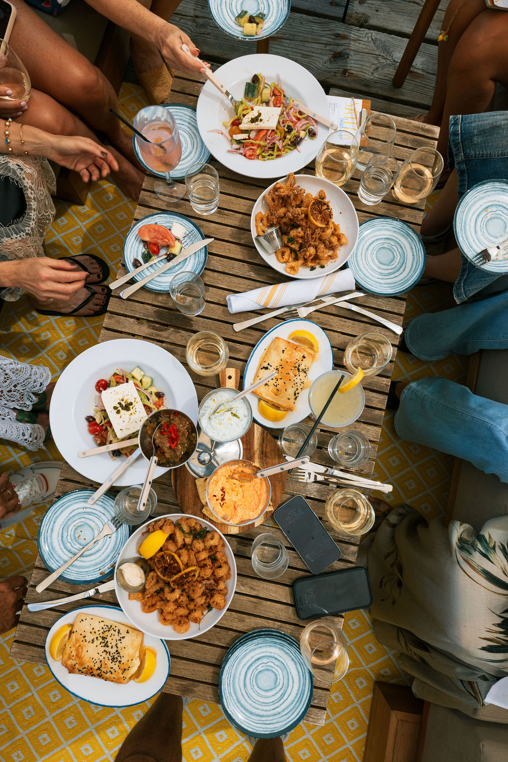 Overhead spread of Mediterranean mezze and shared plates
